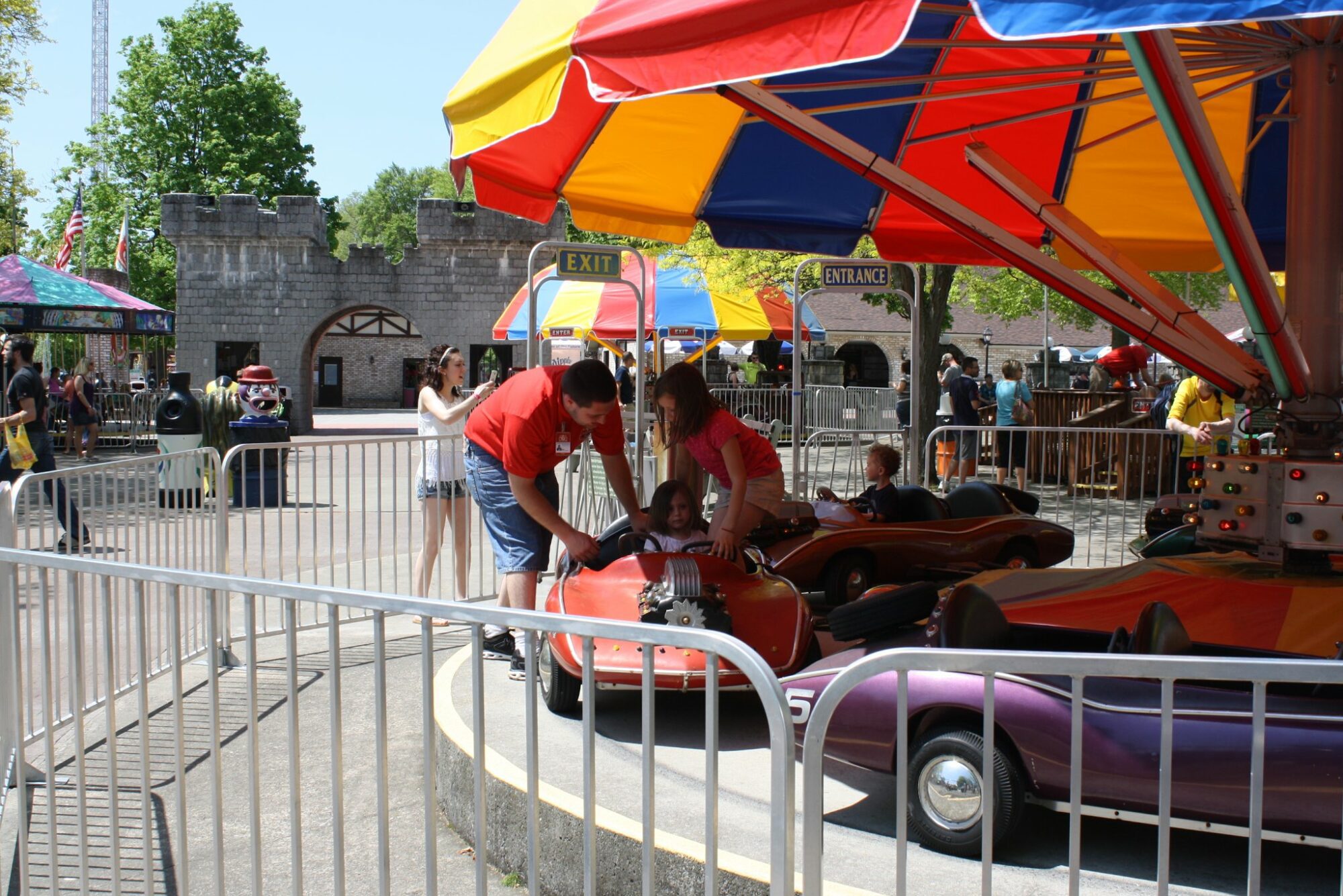 friendly staff members at DelGrosso's helping to buckle in a child on a ride